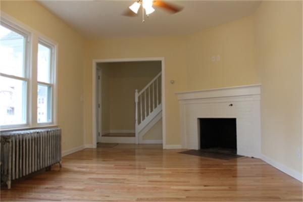 55 Alvin Street Springfield, MA 01104 - Photo 18 of 23 a view of an empty room with wooden floor fireplace and a window