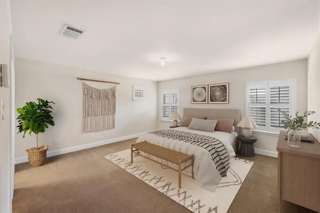 an aerial view of a house with a yard and lake view