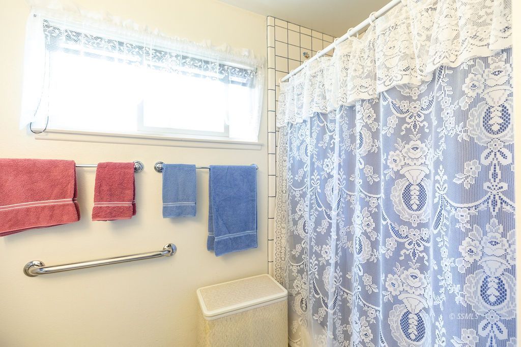 831 Peg Street Ridgecrest, CA 93555 - Photo 20 of 32 a bathroom with a granite countertop sink a mirror and shower