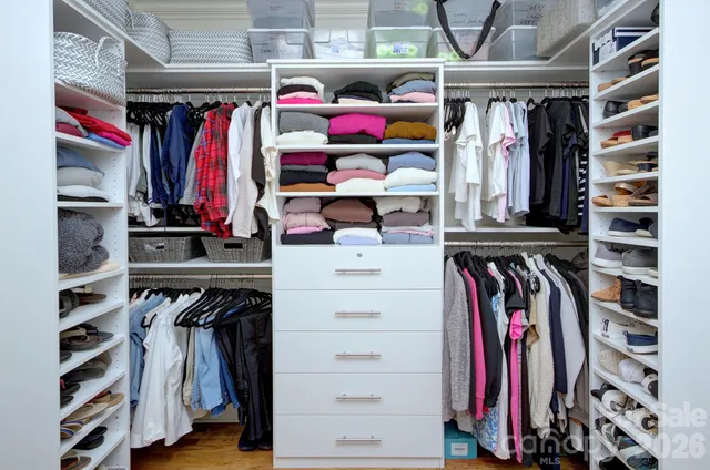 a bedroom with two beds and painting on the wall