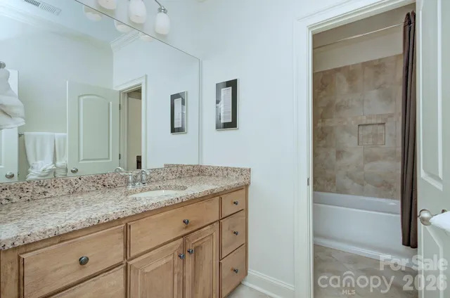 a bedroom with a bed and a night stand