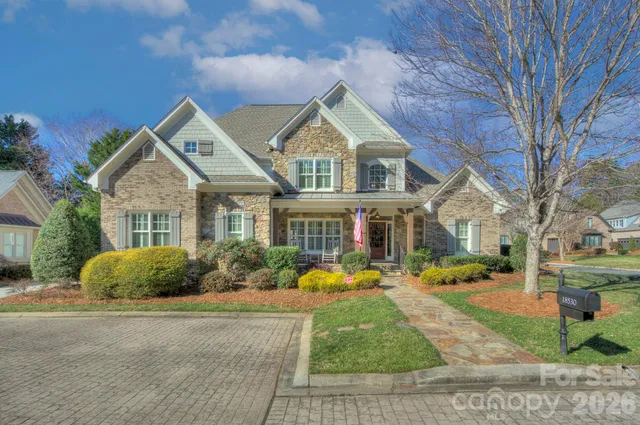 a view of a garden with flowers and trees