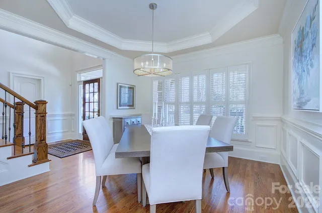 a view of a dining room with furniture wooden floor and chandelier