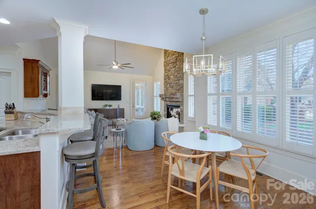 a kitchen with kitchen island granite countertop wooden cabinets and stainless steel appliances