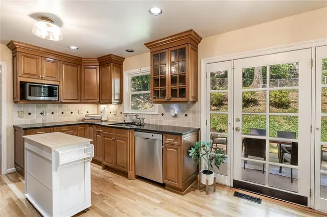 a kitchen with stainless steel appliances granite countertop a stove and a sink