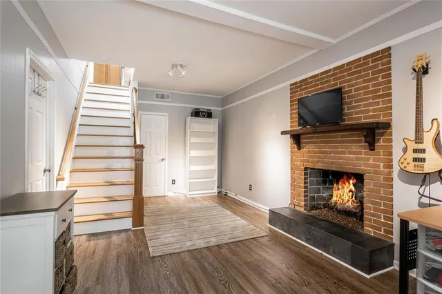 a living room with a fireplace and a flat screen tv