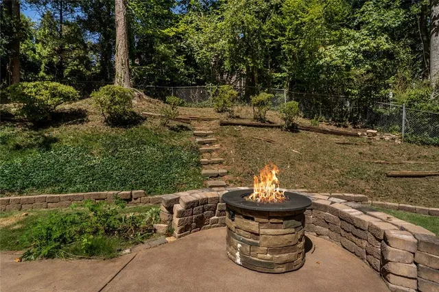 a view of a water fountain with large trees