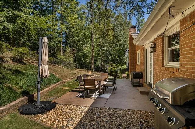 a view of a patio with table and chairs and potted plants