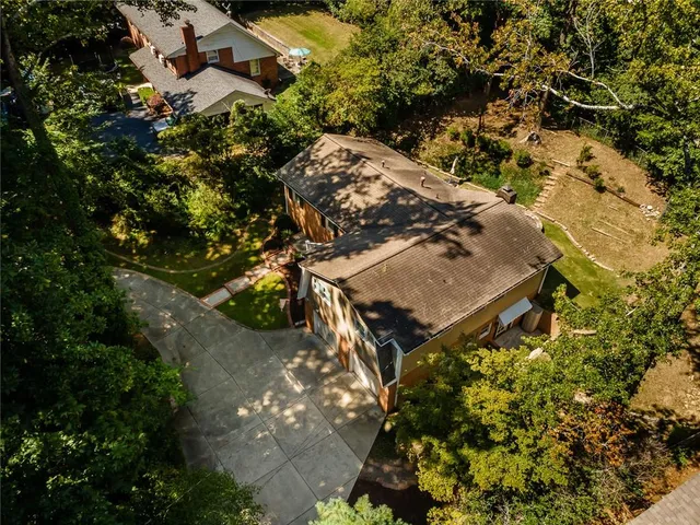 an aerial view of a house with a yard