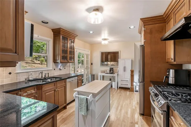 a kitchen with a sink stove and cabinets