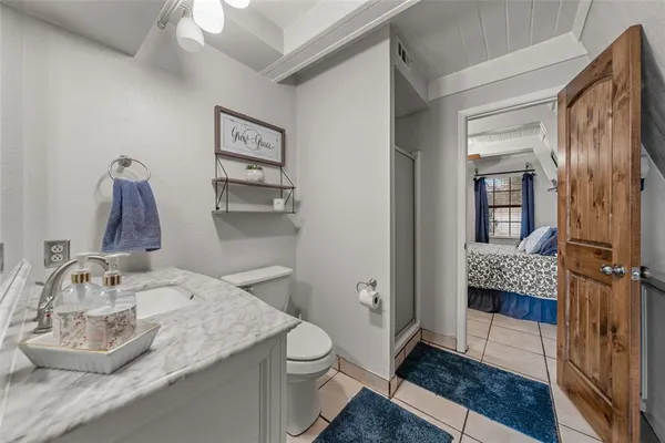 a bedroom with a bed and a mirror