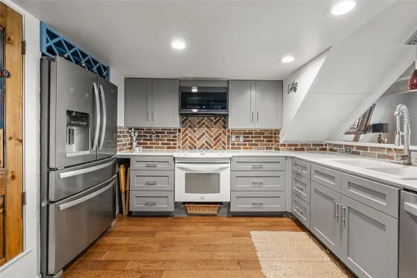 a kitchen with white cabinets and stainless steel appliances