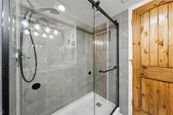 a bathroom with a glass shower door