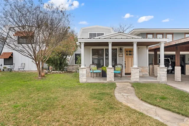 a view of a house with a backyard porch and sitting area