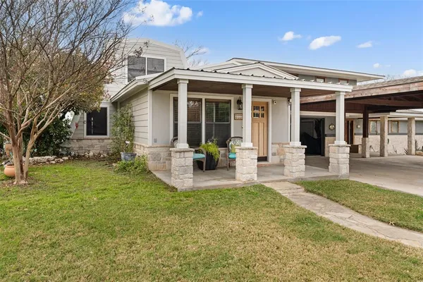 a front view of a house with a garden and porch