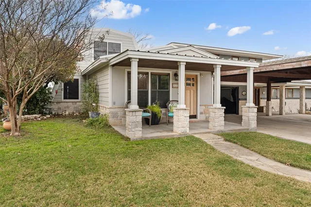 a front view of a house with a garden and porch