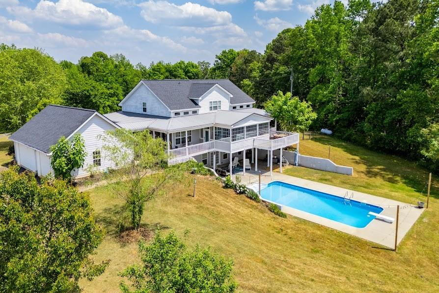 575 Liberty Church Road Carrollton, GA 30116 - Photo 3 of 95 an aerial view of a house with a big yard and large trees