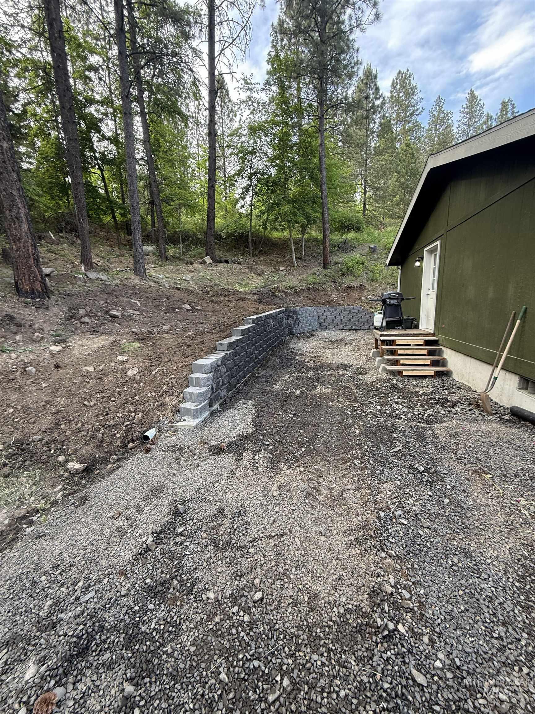 174 Konkolville Road Orofino, ID 83544 - Photo 35 of 43 Gravel area with a multi-tiered retaining wall constructed from modular blocks