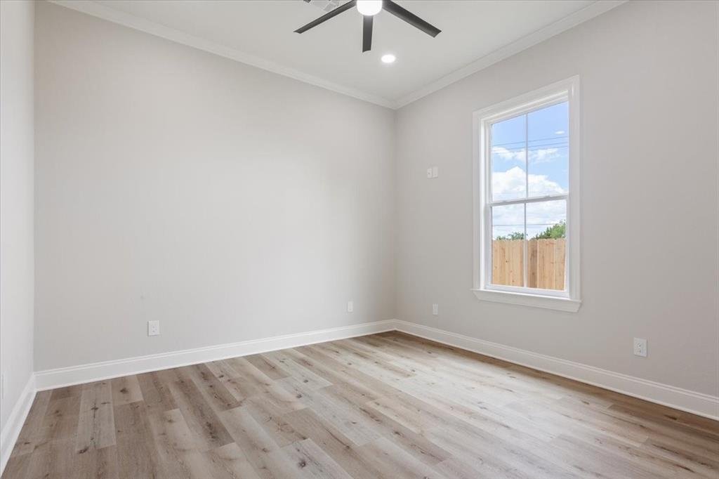 107 North Jena Street Riesel, TX 76682 - Photo 20 of 34 an empty room with a window and a ceiling fan