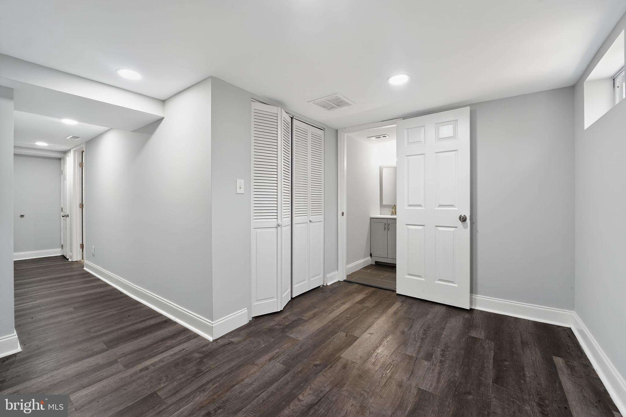 3807 Elkader Road Baltimore, MD 21218 - Photo 17 of 30 wooden floor in an empty room with a window