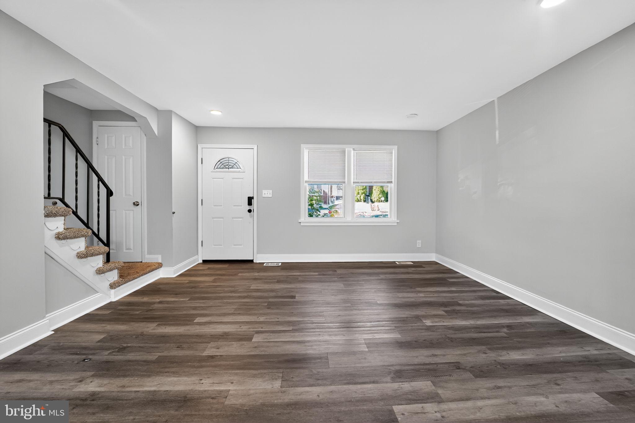 3807 Elkader Road Baltimore, MD 21218 - Photo 20 of 30 a view of an empty room with wooden floor and a window