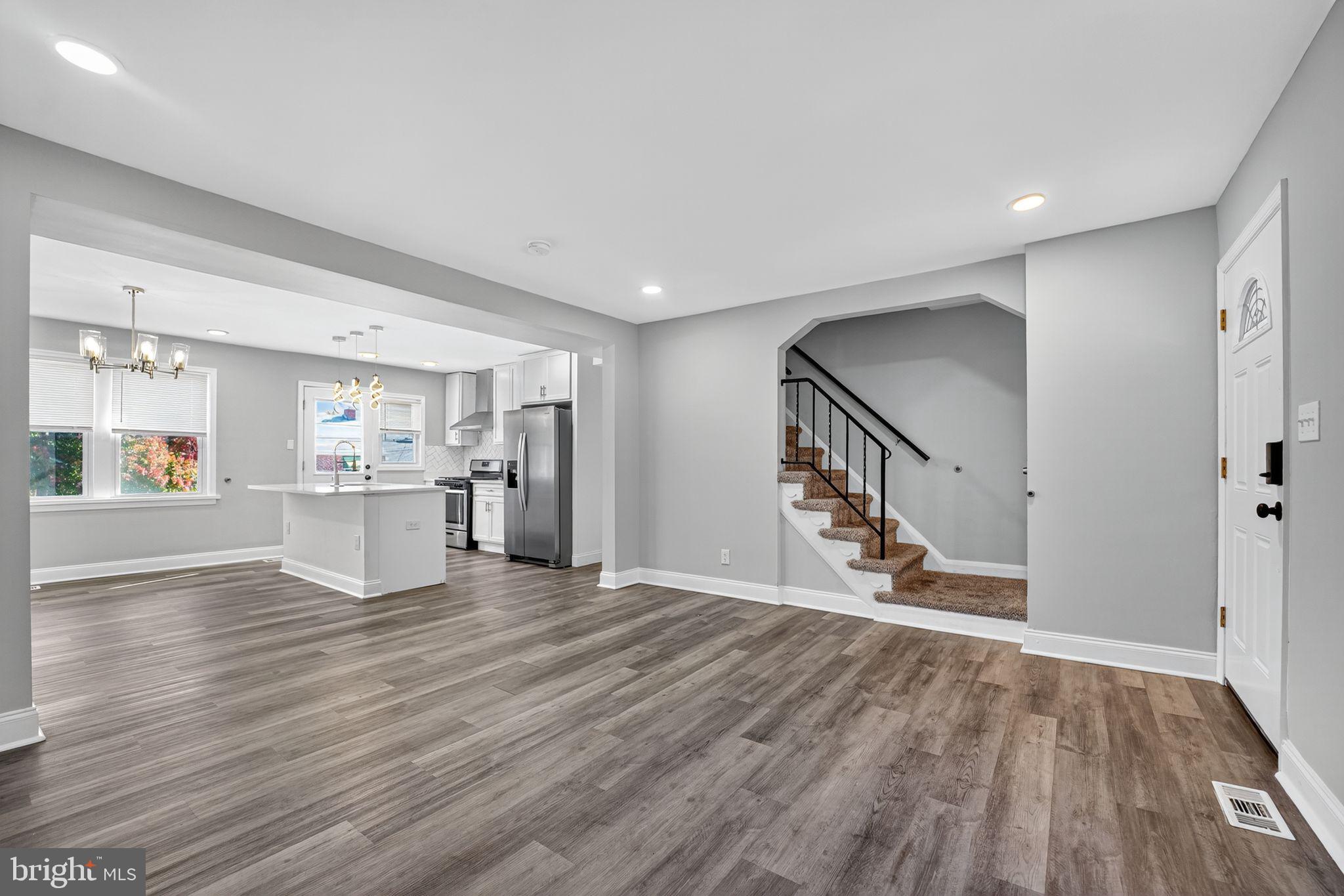 3807 Elkader Road Baltimore, MD 21218 - Photo 2 of 30 a view of a kitchen with wooden floor and a kitchen