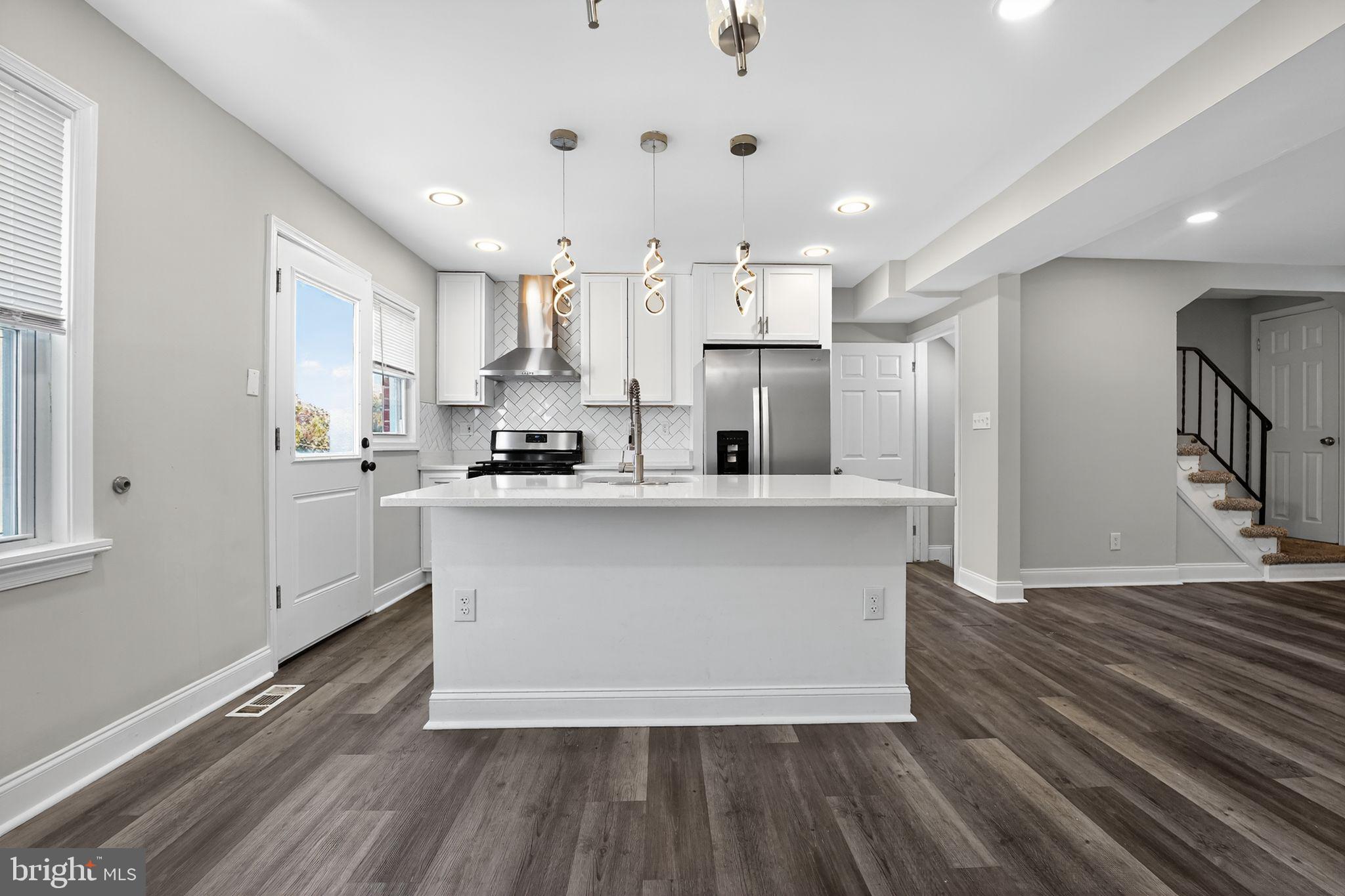 3807 Elkader Road Baltimore, MD 21218 - Photo 3 of 30 a view of kitchen with cabinets and wooden floor