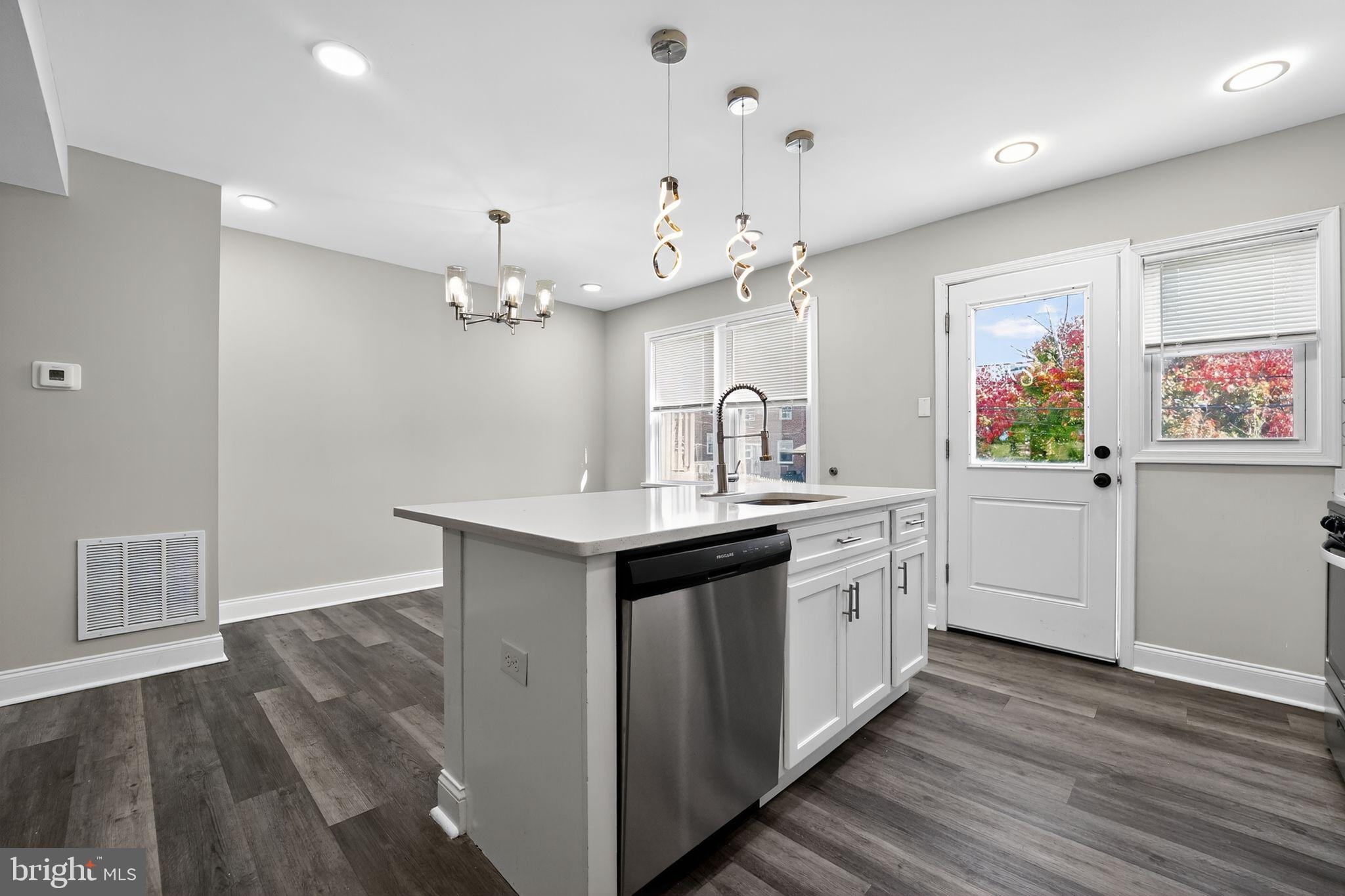 3807 Elkader Road Baltimore, MD 21218 - Photo 7 of 30 a large kitchen with a lot of counter space and wooden floor