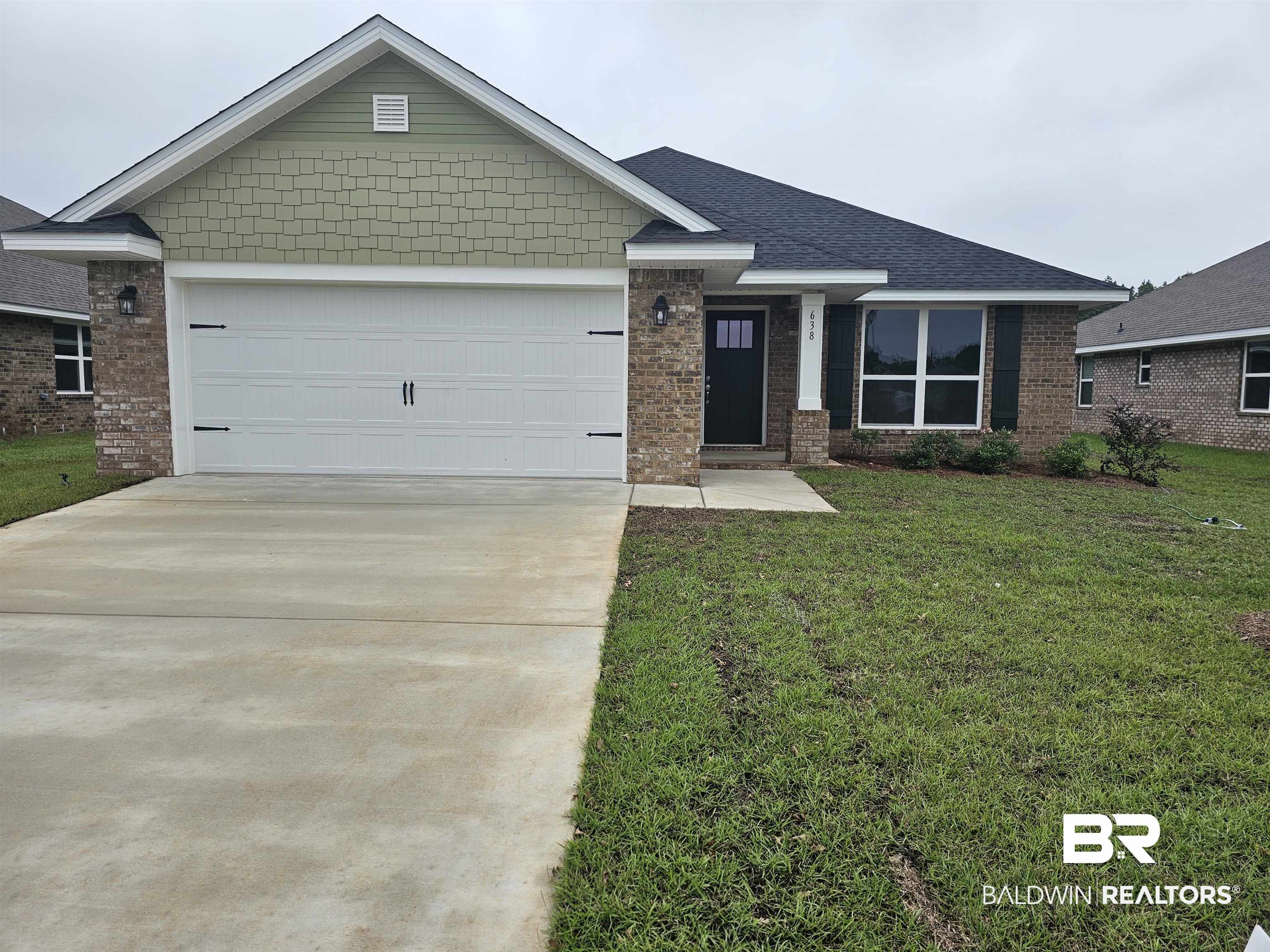 638 Revere Street Foley, AL 36535 - Photo 1 of 16 View of front of home featuring a garage and a front yard