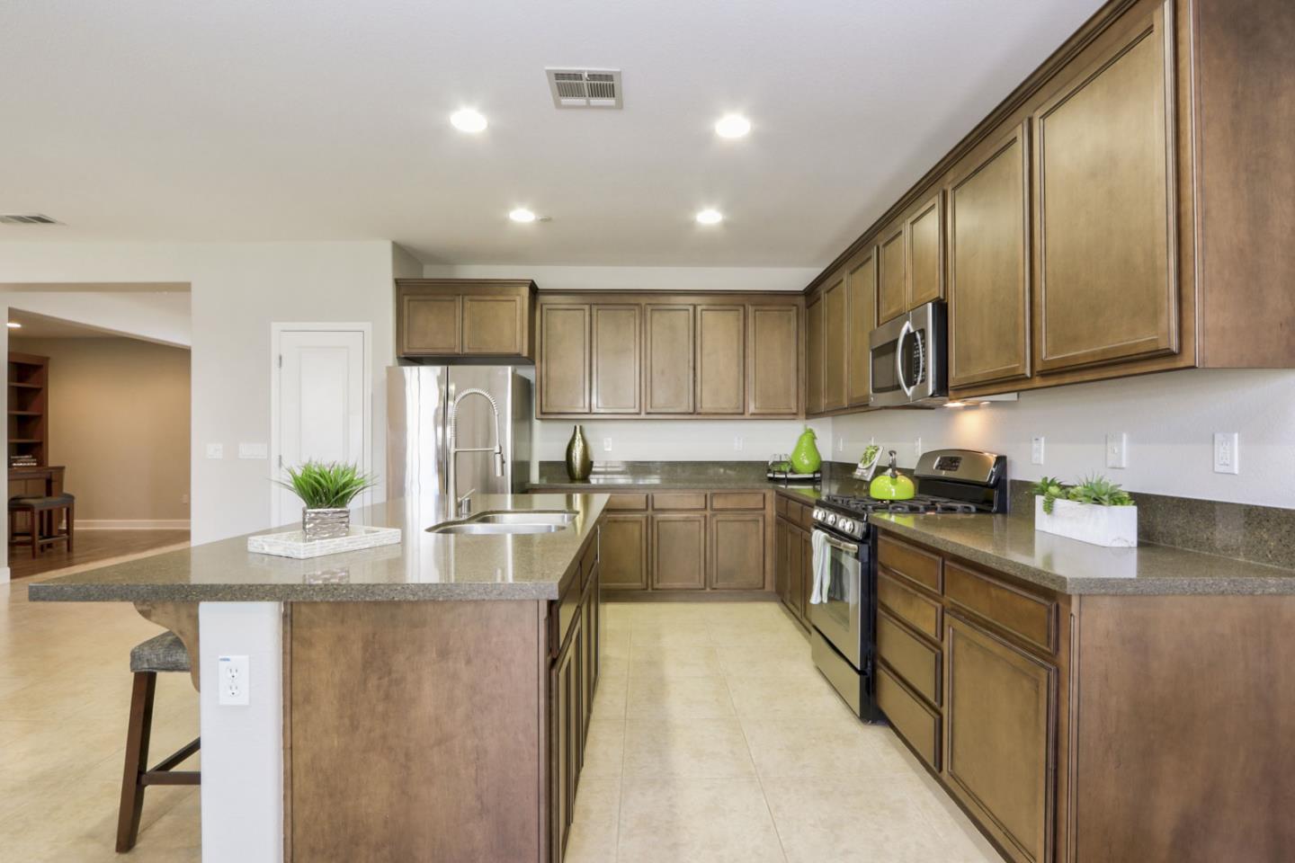 9534 Rodeo Drive Gilroy, CA 95020 - Photo 17 of 73 a kitchen with kitchen island granite countertop a sink counter top space appliances and cabinets