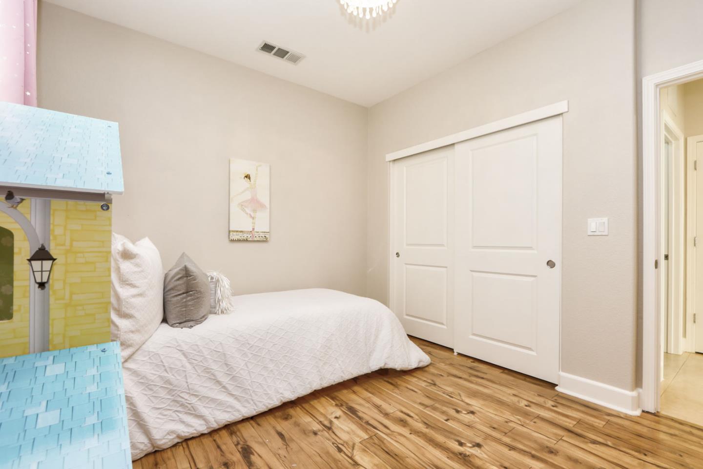 9534 Rodeo Drive Gilroy, CA 95020 - Photo 41 of 73 a bedroom with a bed and wooden floor