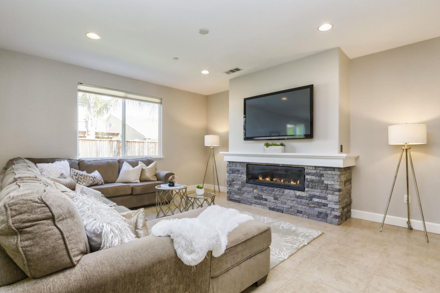9534 Rodeo Drive Gilroy, CA 95020 - Photo 9 of 73 a living room with furniture a fireplace and a flat screen tv