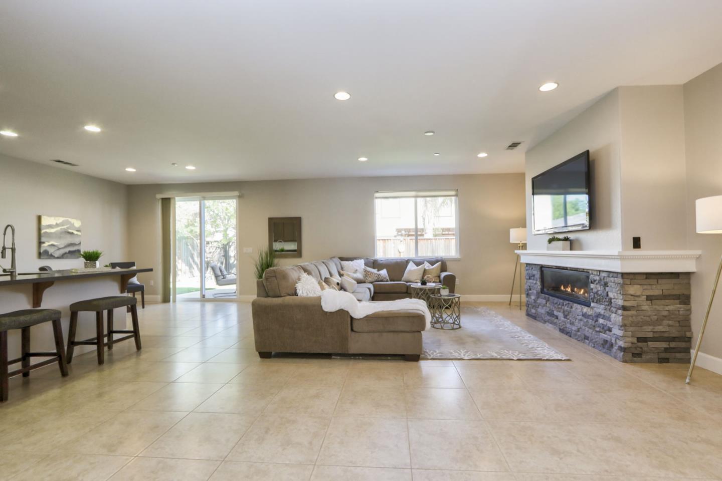 9534 Rodeo Drive Gilroy, CA 95020 - Photo 10 of 73 a living room with furniture a flat screen tv and a fireplace