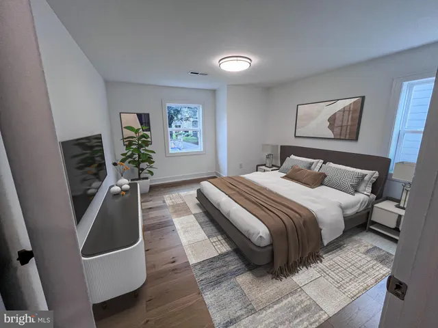 a bedroom with a bed and a painting on the wall