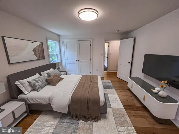 a bed room with a bed and a flat screen tv