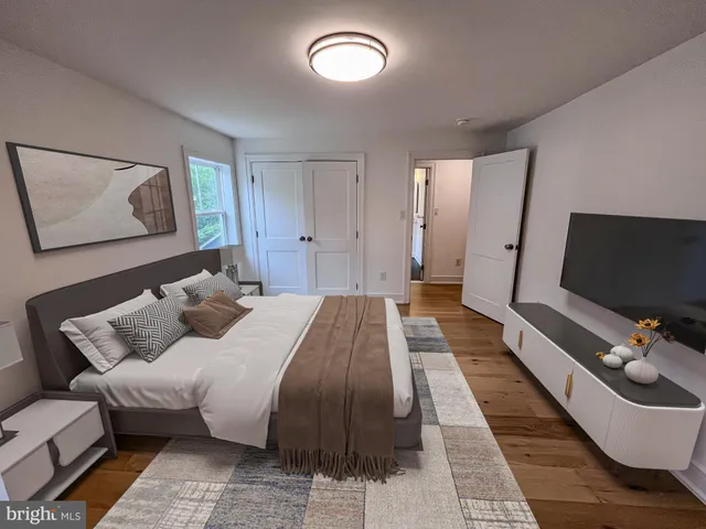 a bed room with a bed and a flat screen tv