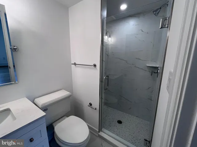 a bathroom with a toilet and a shower