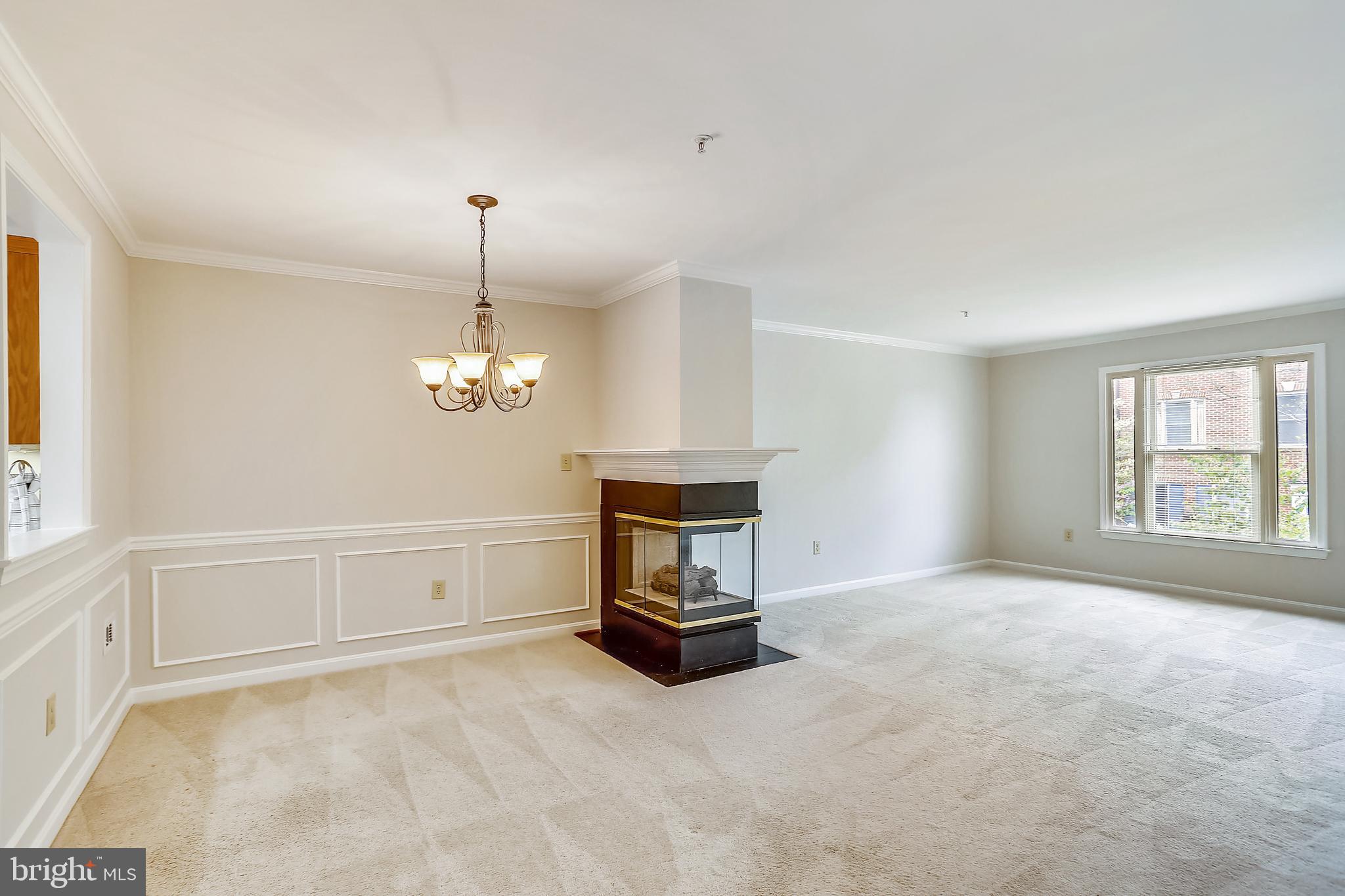 313 Ridgepoint Place Gaithersburg, MD 20878 - Photo 8 of 52 a living room with furniture and a chandelier
