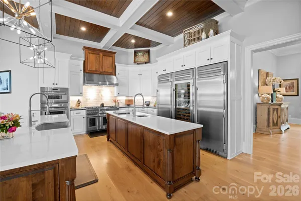 a bedroom with a large bed and a chandelier
