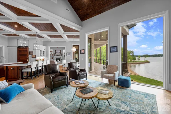 a living room with fireplace furniture and a large window