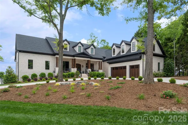 a living room filled with furniture chandelier and a large window