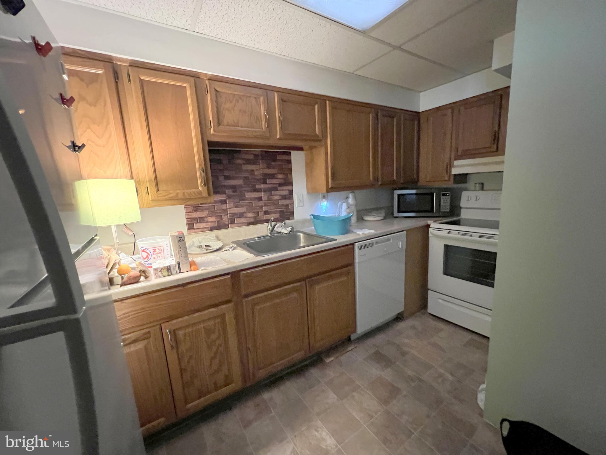 56 Welsh Tract Road Newark, DE 19713 - Photo 16 of 18 a kitchen with a sink stove and cabinets