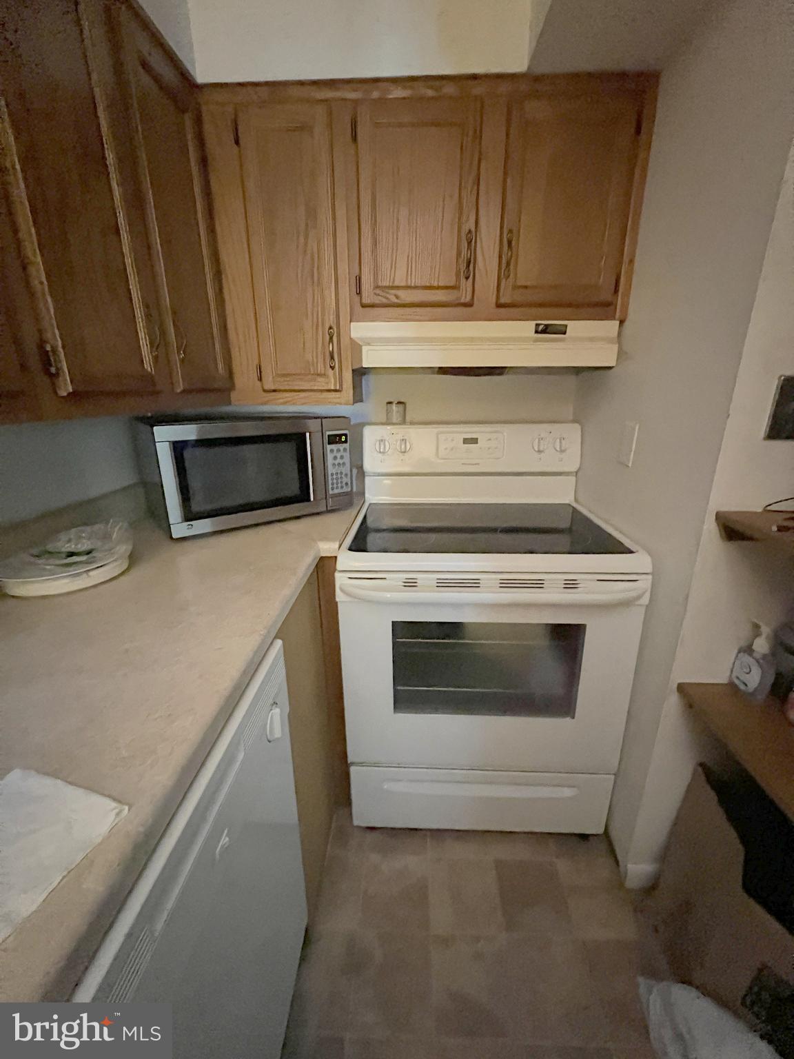 56 Welsh Tract Road Newark, DE 19713 - Photo 3 of 18 a kitchen with granite countertop wood cabinets and stainless steel appliances