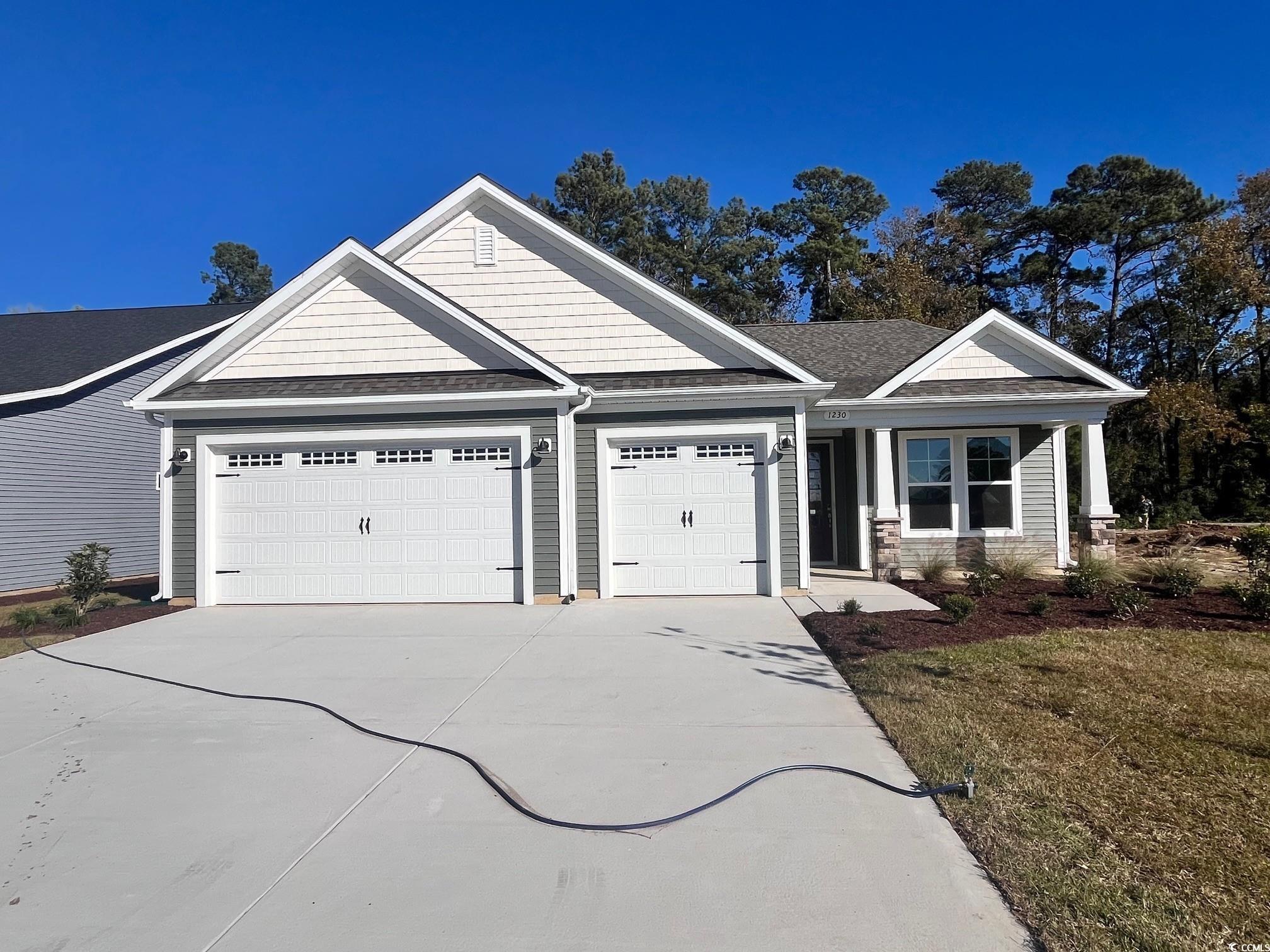 1230 Halter Place Calabash, NC 28467 - Photo 1 of 1 Craftsman house with roof with shingles, concrete driveway, and an attached garage