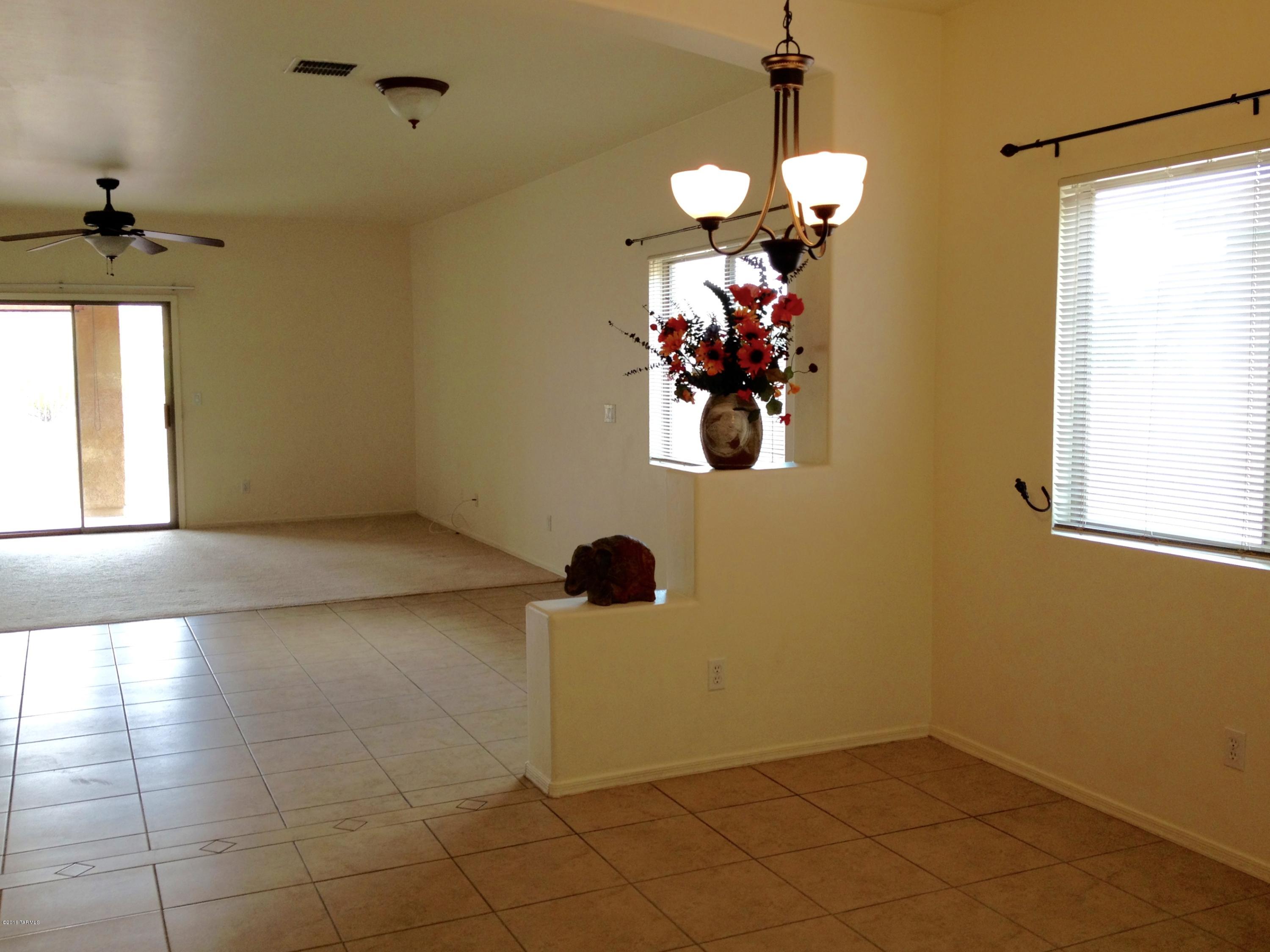 7931 North Iron Ridge Drive Tucson, AZ 85743 - Photo 5 of 21 a view of a hallway with a chandelier