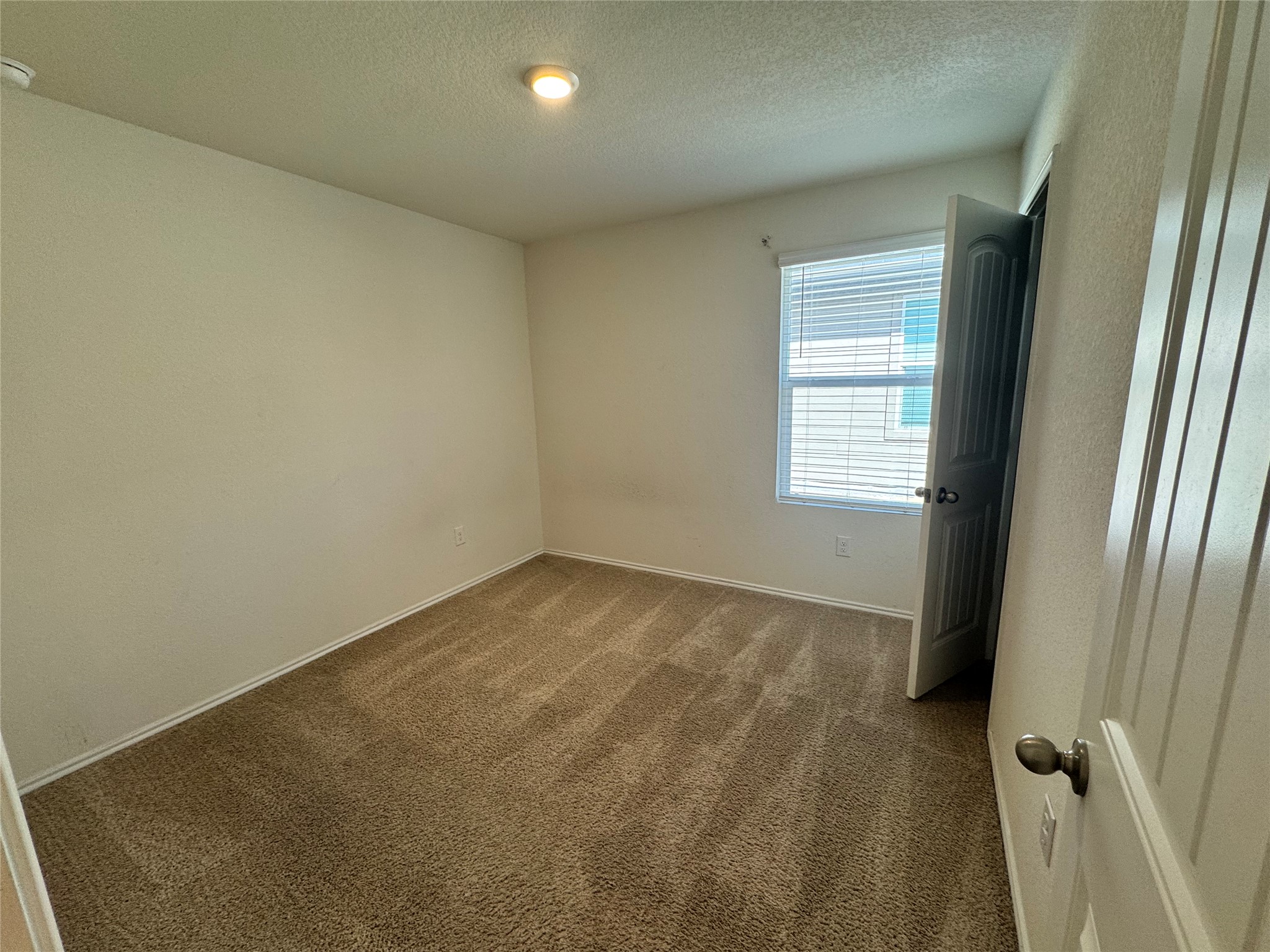 11820 Rush Lane Elgin, TX 78621 - Photo 14 of 31 Well-lit and ready for personalization, this room offers plush carpeting and a bright window.
