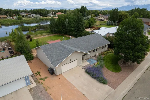 an aerial view of a house with yard
