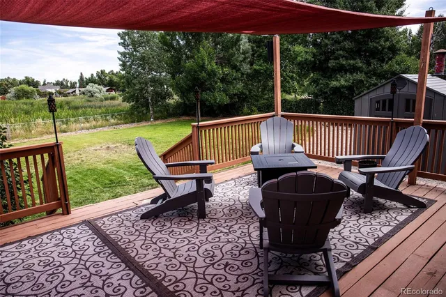 a view of a chair and table on the deck