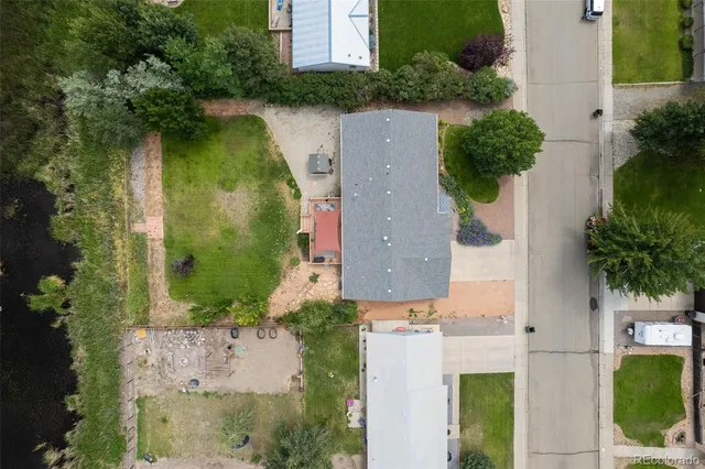 an aerial view of a house with outdoor space and lake view