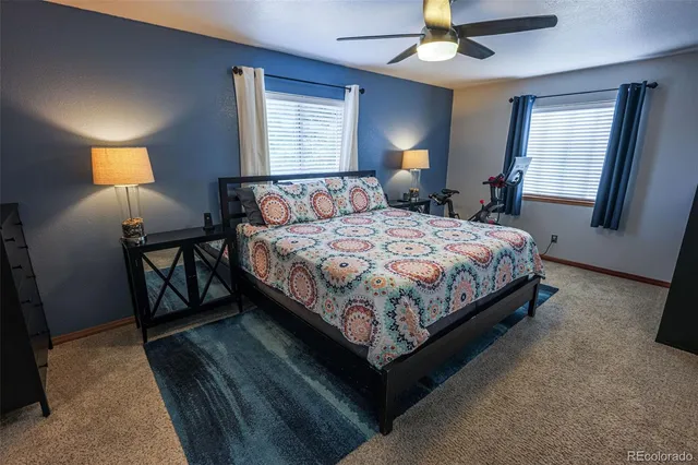 a bedroom with a bed a lamp and a chandelier